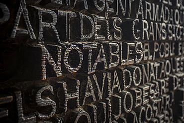 Religious typography on a metal door in Barcelona, Spain.