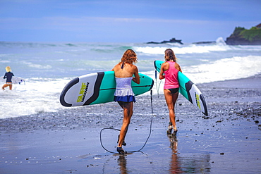 Surfer girls catch waves in high heels.