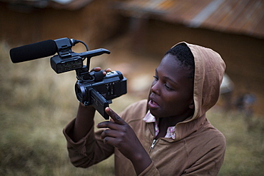 A kid plays with a video camera for the first time.