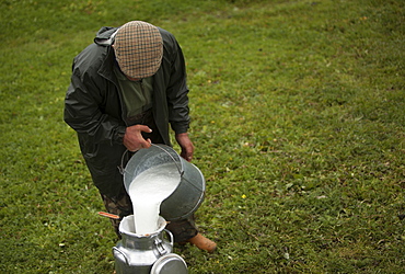 A shepherd collects milk in Villaluenga del Rosario, in the Sierra de Grazalema National Park, Cadiz province, Andalusia, Spain