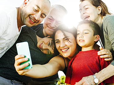 A hispanic family enjoys time together at a park in San Diego, California.