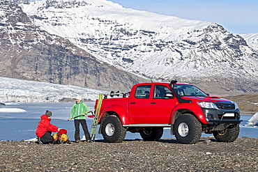 couple getting ready for skitouring in front of customised SUV / Icelandic superjeep