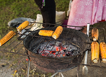 Locals grilling corn on a roadside in Antigua