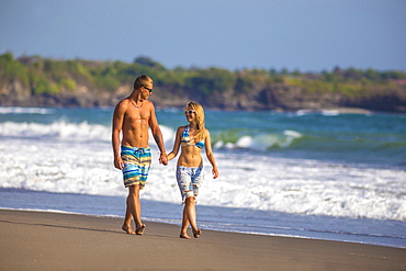 Couple are walking on the beach in Bali. Indonesia