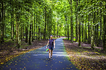 Man preparing for riding on a longboard skate.