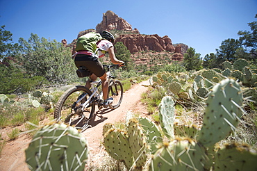 Woman rides the Submarine Rock Loop in South Sedona, Arizona. The trail has everything from slickrock to single track to stairs that lead to Submarine Rock.