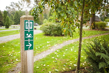 A park sign points to washrooms and a swimming beach.