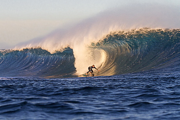 Surfer on a big barreling wave called El Quemao in Lanzarote, Canary Islands, Spain.