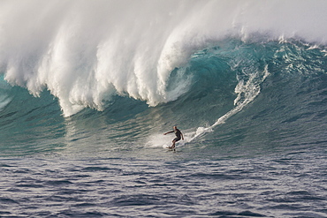 Big wave surfer on a big blue wave