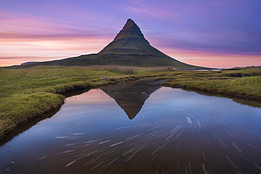 A reflection of Kirkjufell mountain on the Snaefellsnes peninsula in western Iceland.