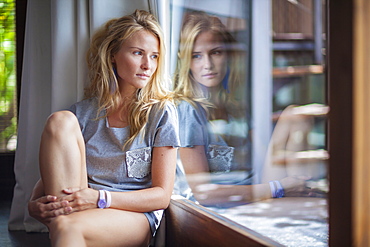 Young woman looking out the window.