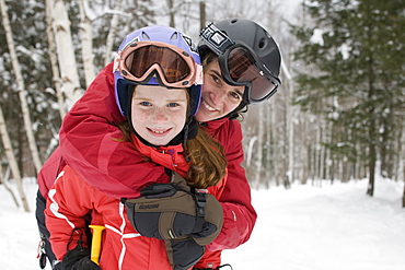 A mother and her child ski together at Sunday River ski resort in Bethel, ME, United States of America