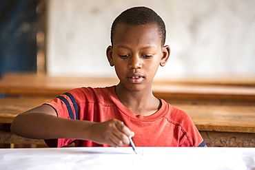 A student works on a project at the Kiziba Refugee Camp in Kibuye, Rwanda.