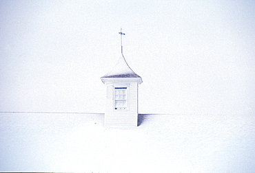 A barn cupola on a post and beam barn in Pownal, ME during a winter storm, United States of America