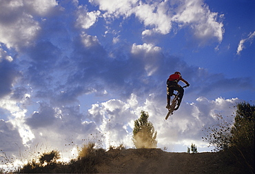 Bruno Penone jumping his mountain bike at sunset in Roussillon, France, France