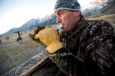 Brad Jackson uses a call to lure geese while hunting in Carson City, NV, United States of America