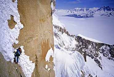 A mountaineer climbs Cerro Torre's northwest face, with the southern Continental Icecap in the background, in Argentine Patagonia. Cerro Torre is one of the most difficult and iconic peaks in the Southern Andes, and is a highly sought after summit by the worlds top alpinists, Argentina