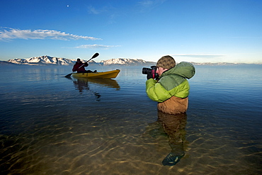 Corey Rich photographs Spencer Ray during an early morning paddle on Lake Tahoe, Stateline, NV, United States of America