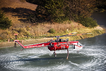 Helicopters pick up water from a reservoir while fighting wildfires in Santa Barbara, California, United States of America