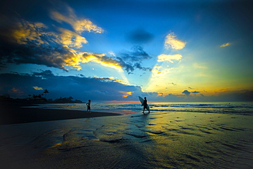 Surfers at sunrise. Bali. Indonesia.