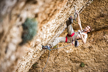 Professional italian climber Gabriele Moroni climbing an 8c route in Margalef, Spain.