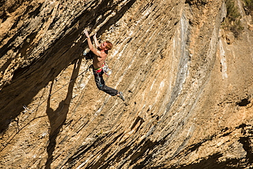 Professional italian climber Gabriele Moroni climbing an 8c route in Margalef, Spain.