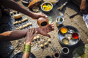 Performing a ceremony for the deceased family members at the Godavari river, Nashik, Maharashtra, India.