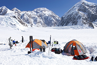 A team of mountaineers is resting in their camp with tents on the lower Kahiltna glacier on their way to Mount McKinley in Alaska.