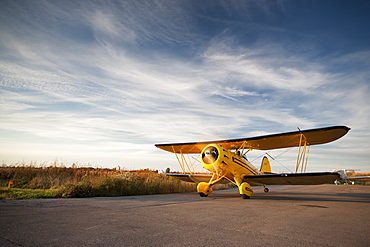 Old yellow bi-plane on the runway