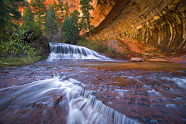 Waterfall in sandstone canyon, Zion National Park, Utah.