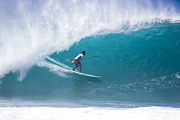 A man SUP surfing at Pipeline and Backdoor, north shore, 02.12.08