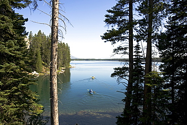 Kayakers leave the shore of Leigh Lake in Grand Teton National Park.