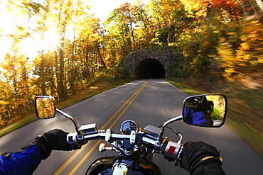 Motorcycle rider out for a cruise on a beautiful fall day on the Blue Ridge parkway south of Asheville, NC