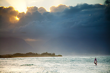 Dramatic sky with windsurfer in silhouette.