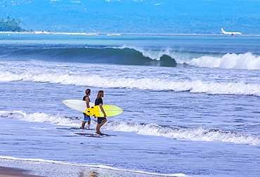 Surfers on a beach,Bali,Indonesia.