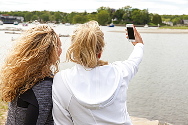 Two friends taking selfies