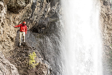 A man hiking below Treasure Falls, San Juan National Forest, Pagosa Springs, Colorado.