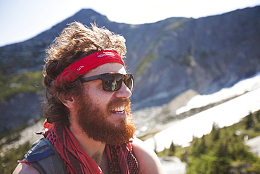 Portrait of Evan Howard, a climber and explorer, wearing a bandana and sporting a thick beard.