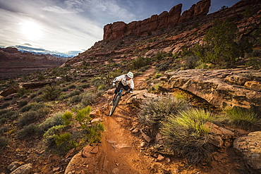 A man mountain biking on the Hymasa trail, Moab, Utah.