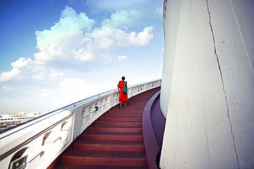 Monks are going up the stairs to reach the temple. Thailand Bangkok