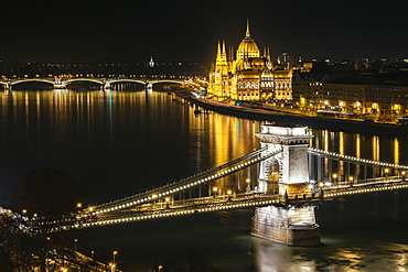 Night photo of the Parliament and the bridges in Budapest from across the Danube river