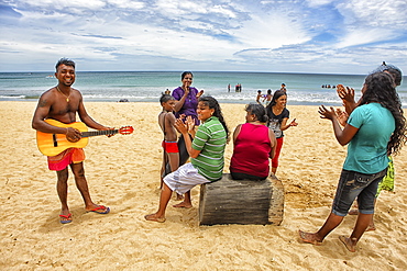 Sri Lankans singing in Nilaveli Beach. Trincomalee. Sri Lanka