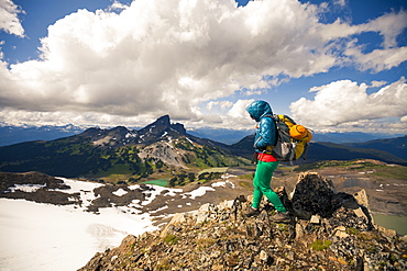 A young woman hiking on Panorama Ridge with Black Tusk Mountain in the background in Garibaldi Provincial Park, British Columbia, Canada.