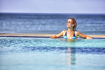 Woman sunbathing by a pool in Nilaveli. Sri Lanka