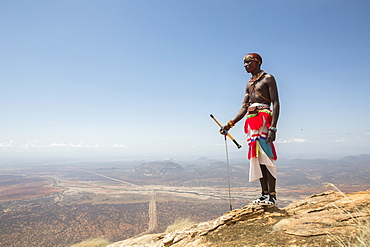 A Samburu warrior stands at the top of Mount Ololokwe in Samburu, Kenya.