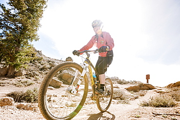 Smiling Woman Mountain Biking On Rocky Landscape In Gunnison