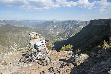 Mountain Biker Descending A Rocky Trail In Mexico