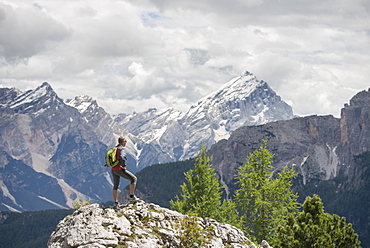 Female Hiker Standing On Rock In Cinque Torri Area At Dolomites, Italy