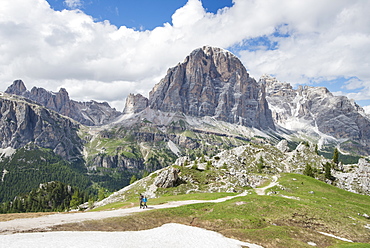 Long Exposure Of Couple Hiking At Cinque Torri Area In Dolomites, Italy