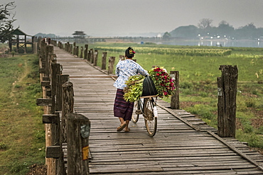 A Local Flower Seller With Bike At The U Bein Bridge In Amarapura, Myanmar